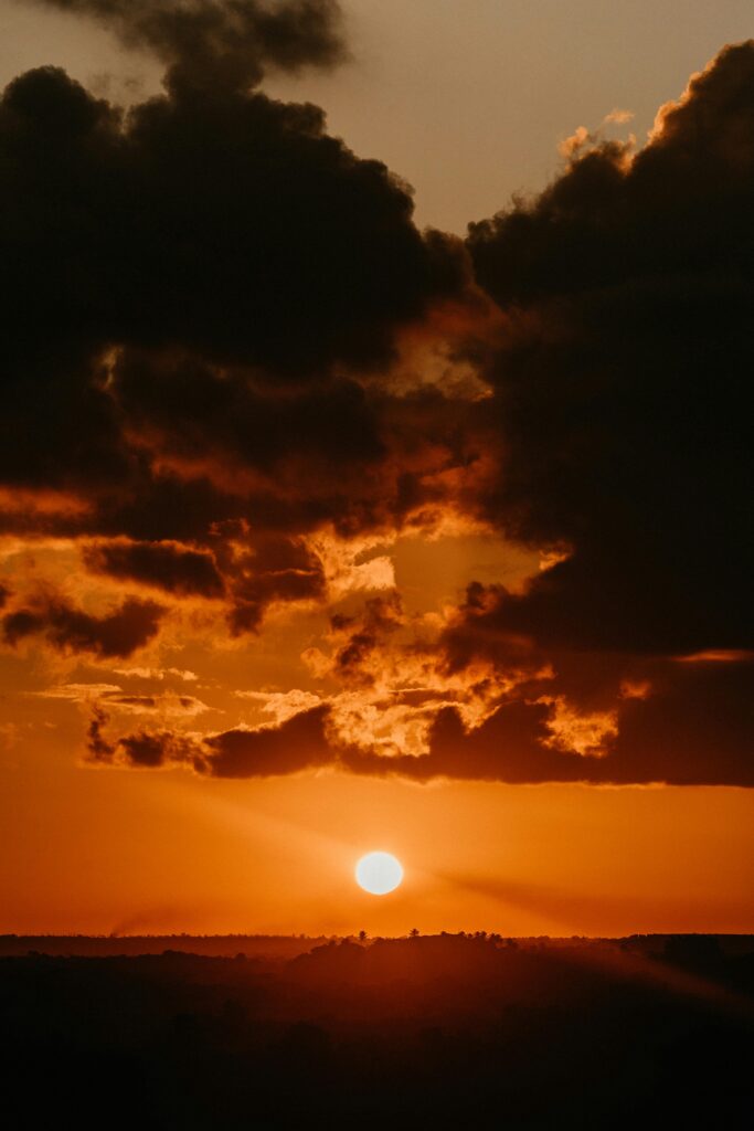 A breathtaking view of a dramatic sunset with golden clouds on the horizon.